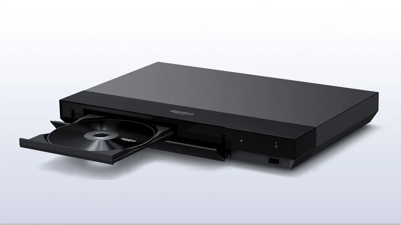 A Sony Ultra HD Blu-ray player placed beneath a television in a home theater setup.