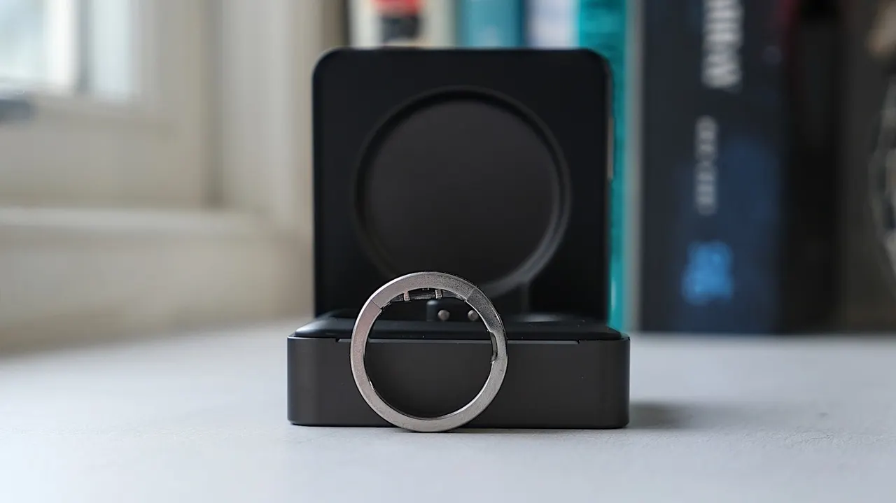 A close-up of a smart ring on a table beside a gavel, symbolizing a patent dispute between two wearable makers.