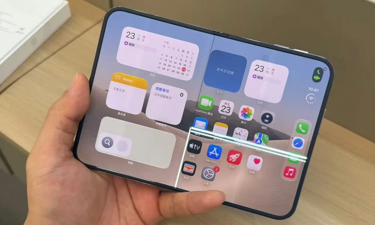 A foldable iPhone Duo opened to show its inner display, with a crack visible near the hinge.