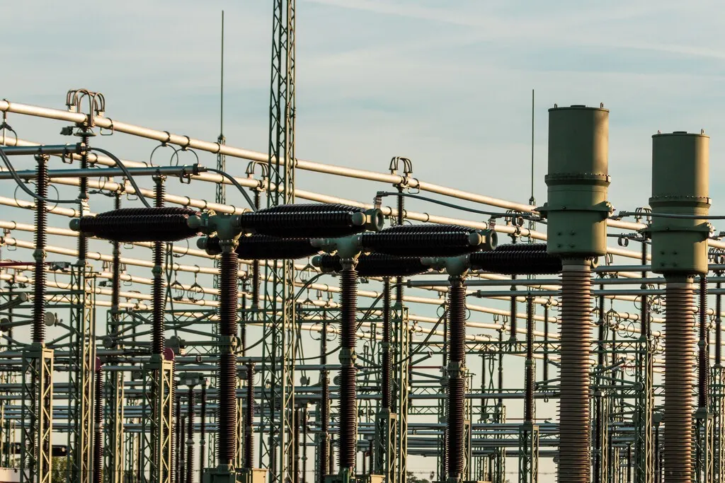 Large synchronous condenser machine installed in a high-voltage electrical substation in Spain.