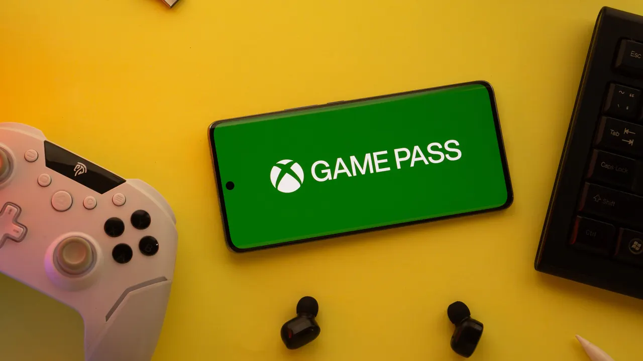 Xbox controller next to a screen showing the Game Pass subscription menu with selectable options.