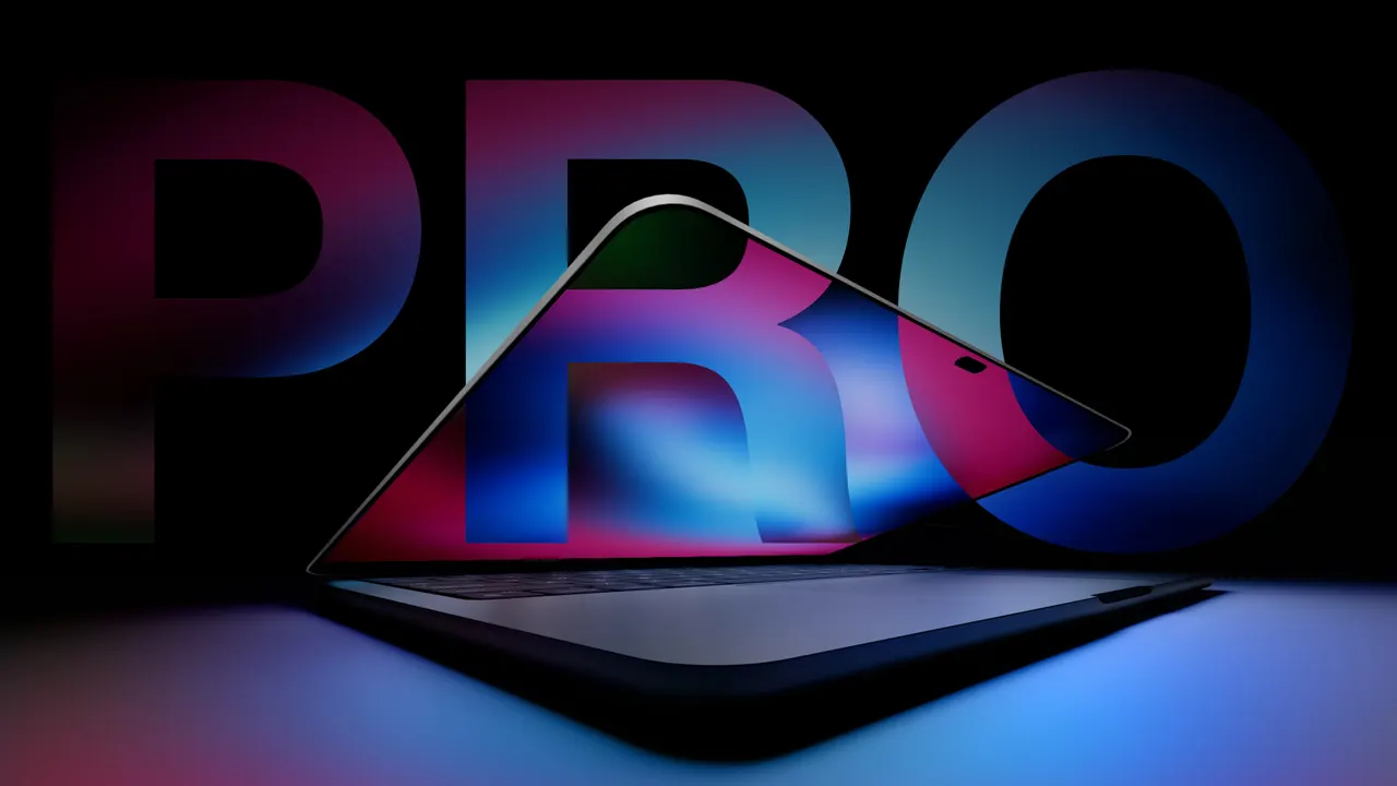 A silver MacBook Pro laptop open on a desk, showing a touch-enabled OLED display with a Dynamic Island at the top of the screen.