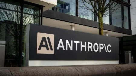 Anthropic logo displayed in front of a stock market chart symbolizing the company's planned Nasdaq listing.