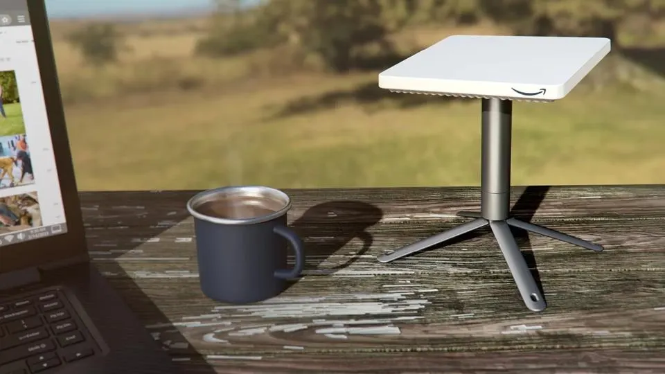 A compact satellite internet antenna set up outdoors with a laptop connected, representing Amazon's Leo Pro terminal test.