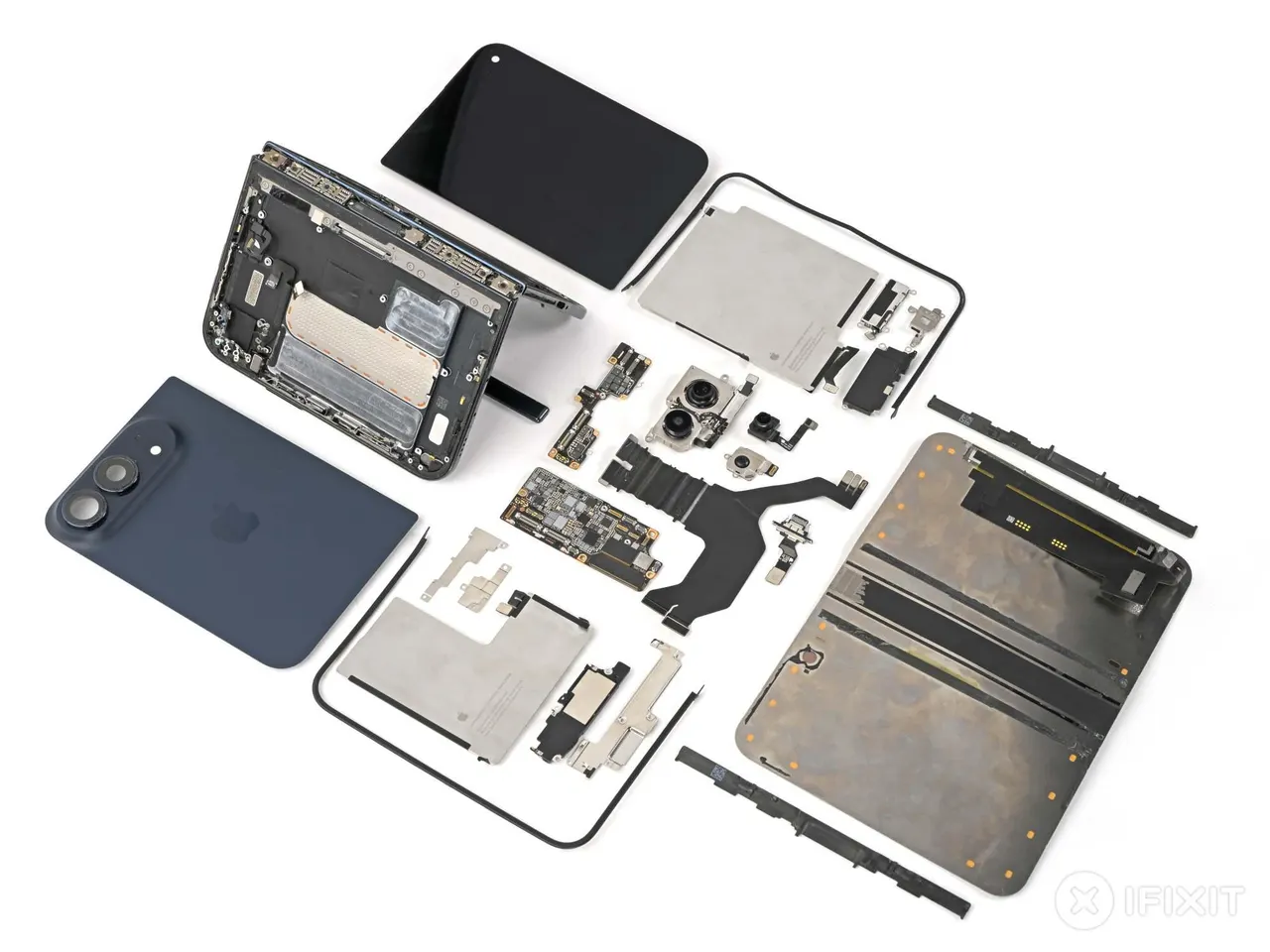 An iPhone Duo foldable phone taken apart on a workbench, with its hinge and folding display exposed during a teardown.