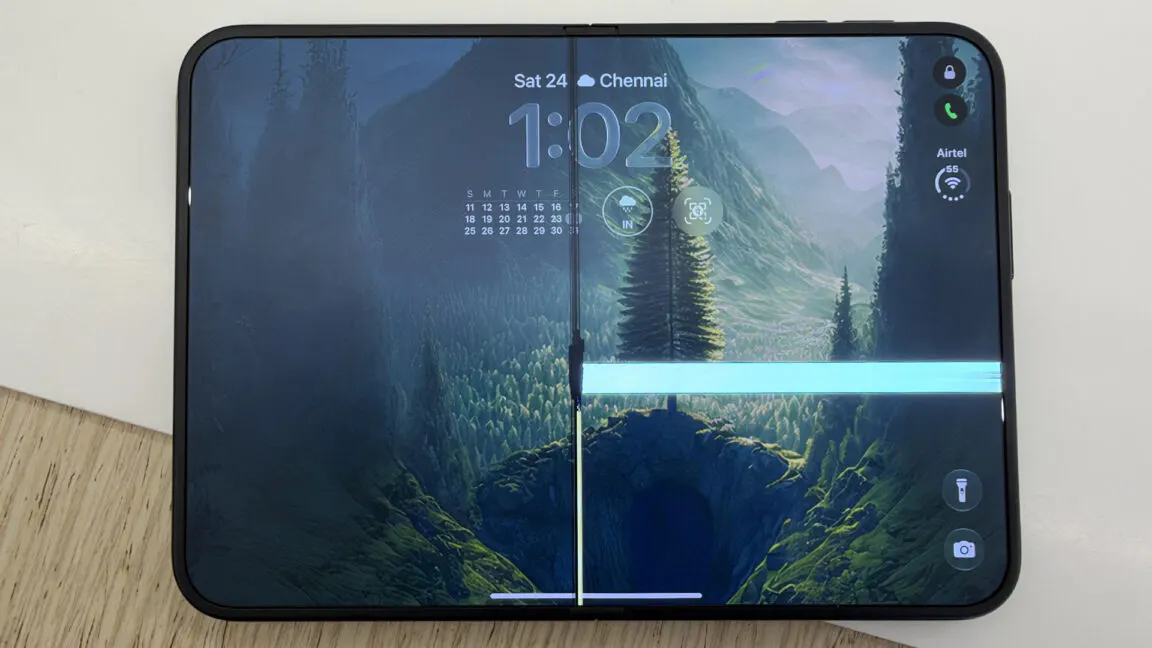 An Apple iPhone Duo foldable phone opened to show an inner OLED display with bright vertical lines of damaged pixels.