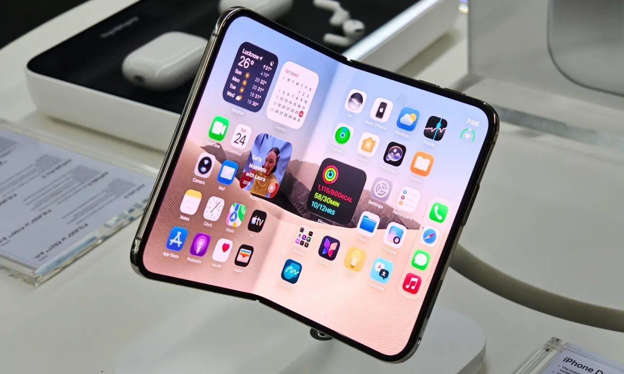 A foldable iPhone Duo opened on a repair bench with precision tools and a printed repair manual beside it.