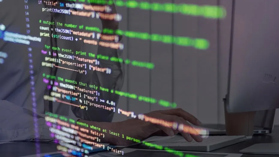 Server rack with a warning symbol on a monitor showing PHP code, illustrating the actively exploited php2shell vulnerabilities.