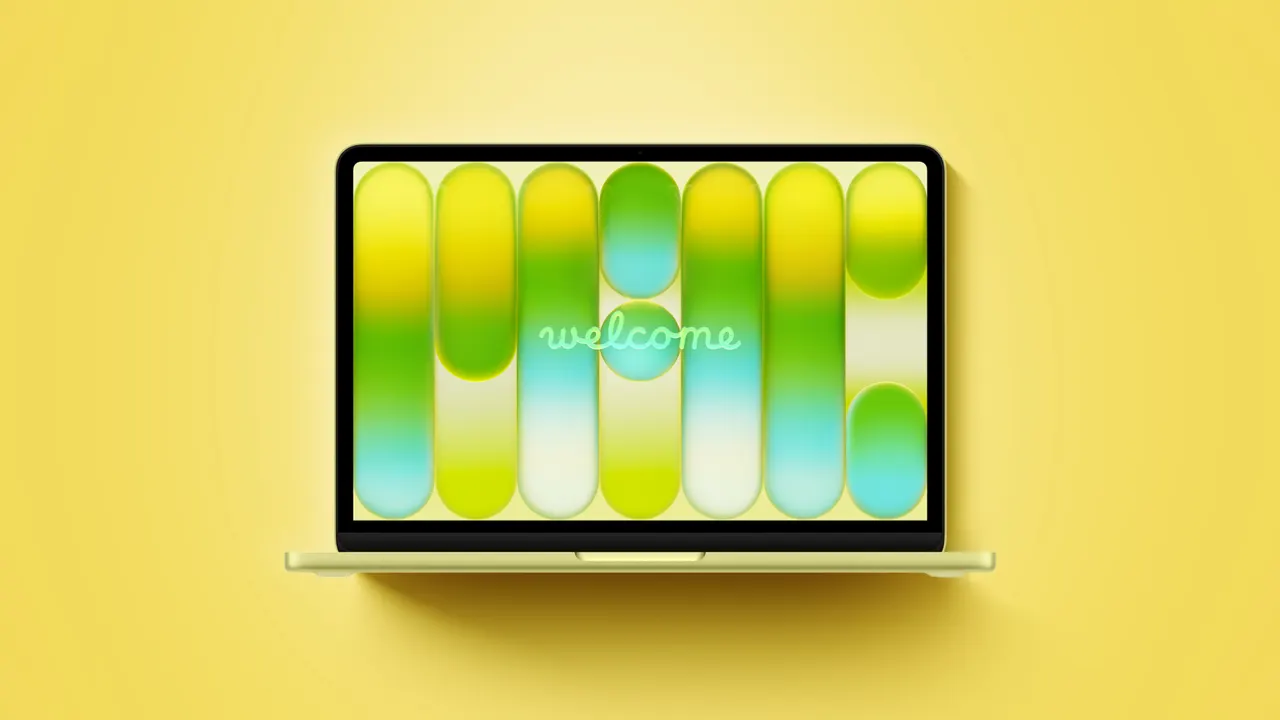 A thin Apple laptop in several pastel colors, representing the MacBook Neo lineup, open on a desk.