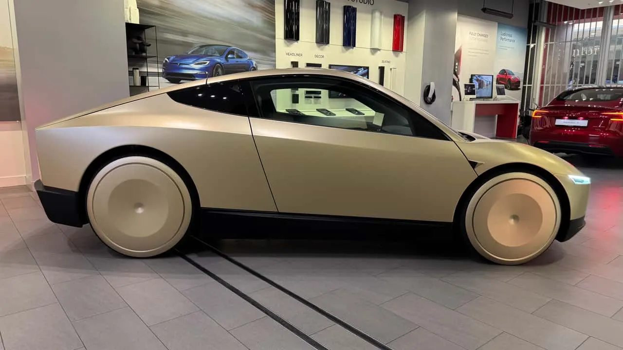 Cutaway view of a Tesla structural battery pack beneath the floor of an electric vehicle.