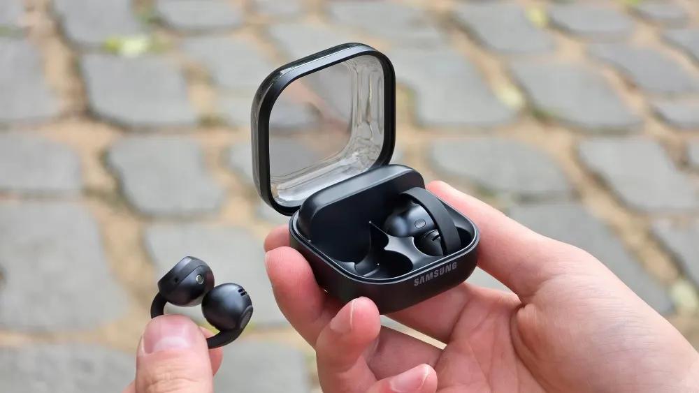 Samsung Galaxy Buds On clip-style open-ear earbuds in black shown with their wireless charging case.