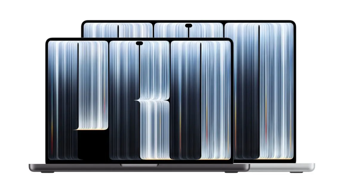A silver MacBook Pro with an OLED touchscreen display and a glowing Apple logo on the lid.