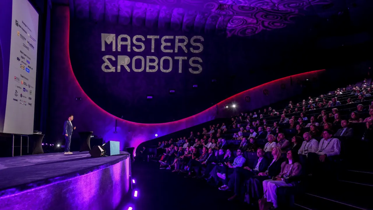A humanoid robot walks a runway in a fashion show at the Masters & Robots conference in Warsaw while an audience watches.