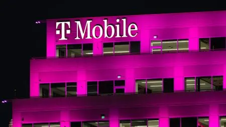 Magenta Telekom and T-Mobile logos on a building facade, symbolising the paused merger plans between the German parent and its US subsidiary.