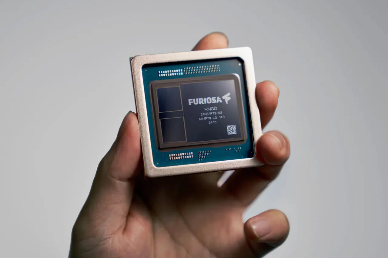 A close-up of an AI accelerator chip on a circuit board under blue lighting, representing FuriosaAI's RNGD processor.