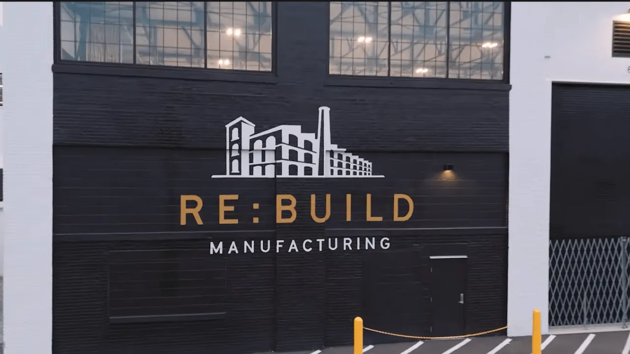 Engineers working on a modern manufacturing floor with advanced production equipment in a large US factory.