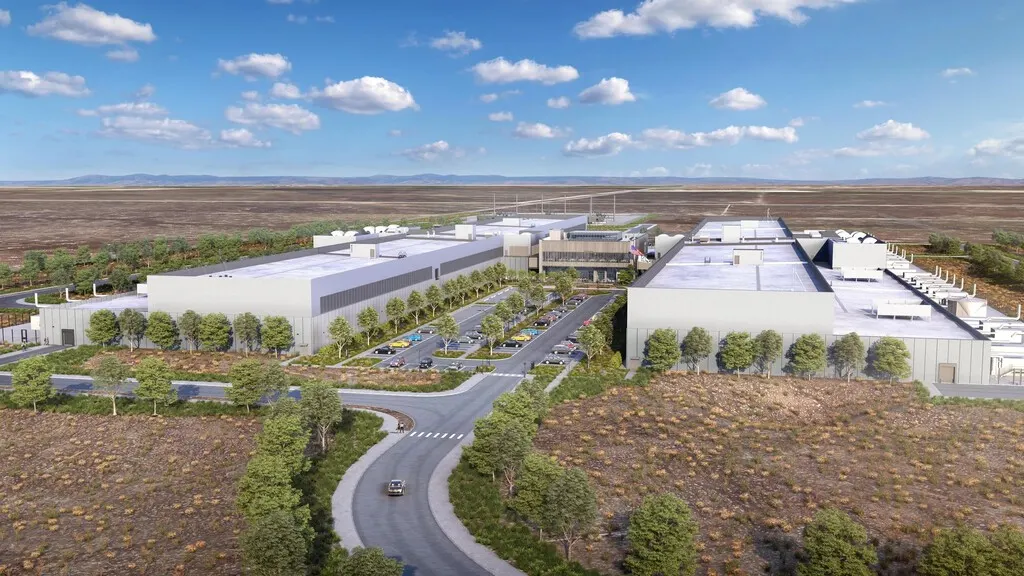 Aerial view of a large data center complex with cooling equipment on dry farmland in Aragon, Spain.