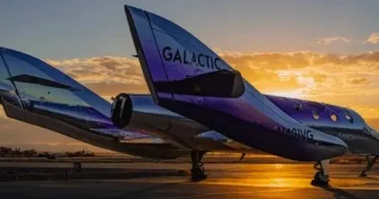Virgin Galactic's Delta-class spaceship Apeiron attached beneath its Eve carrier aircraft at Spaceport America in New Mexico.