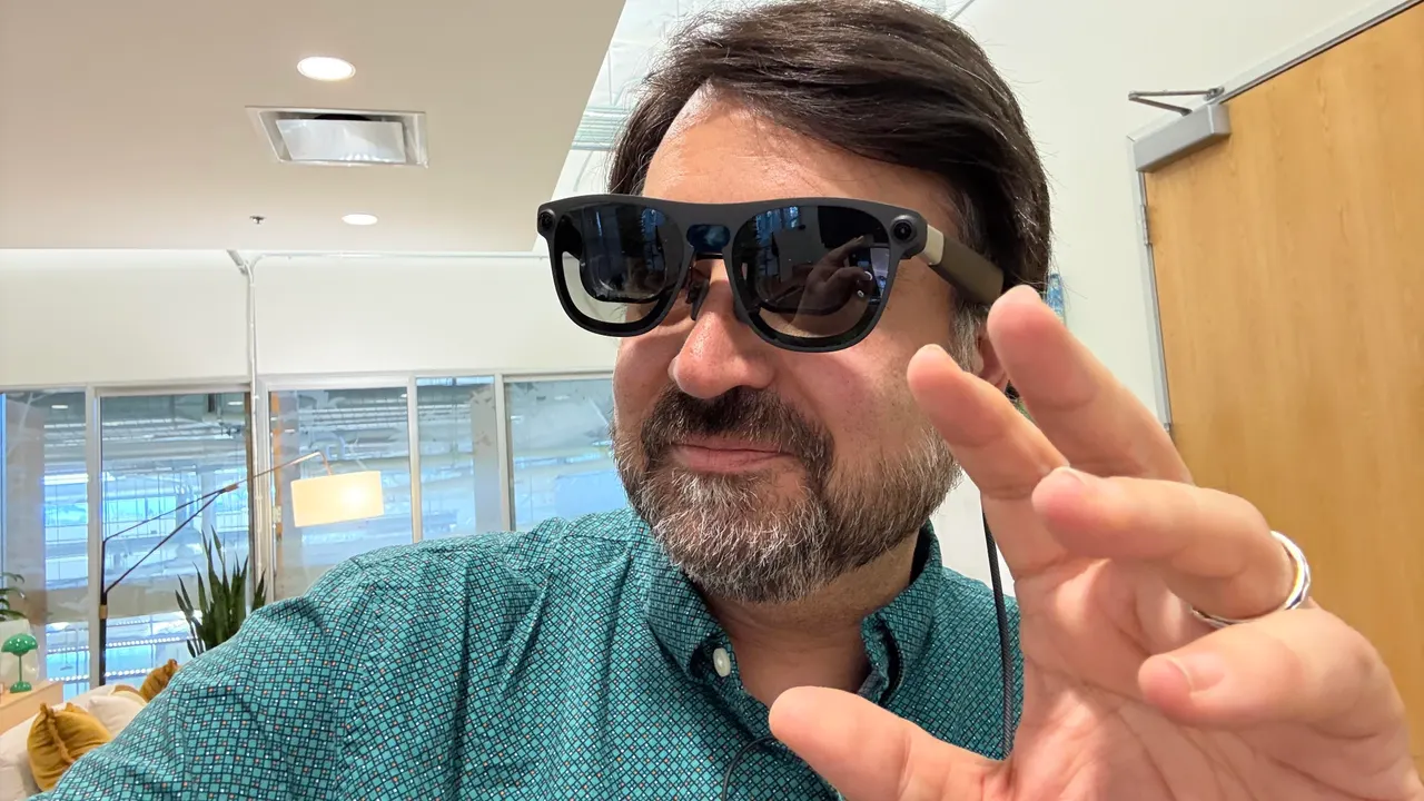 Xreal Aura display glasses with the connected processor puck and folding keyboard accessory