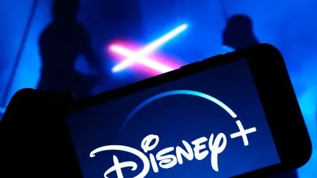 A television showing the Disney+ streaming interface in a living room.