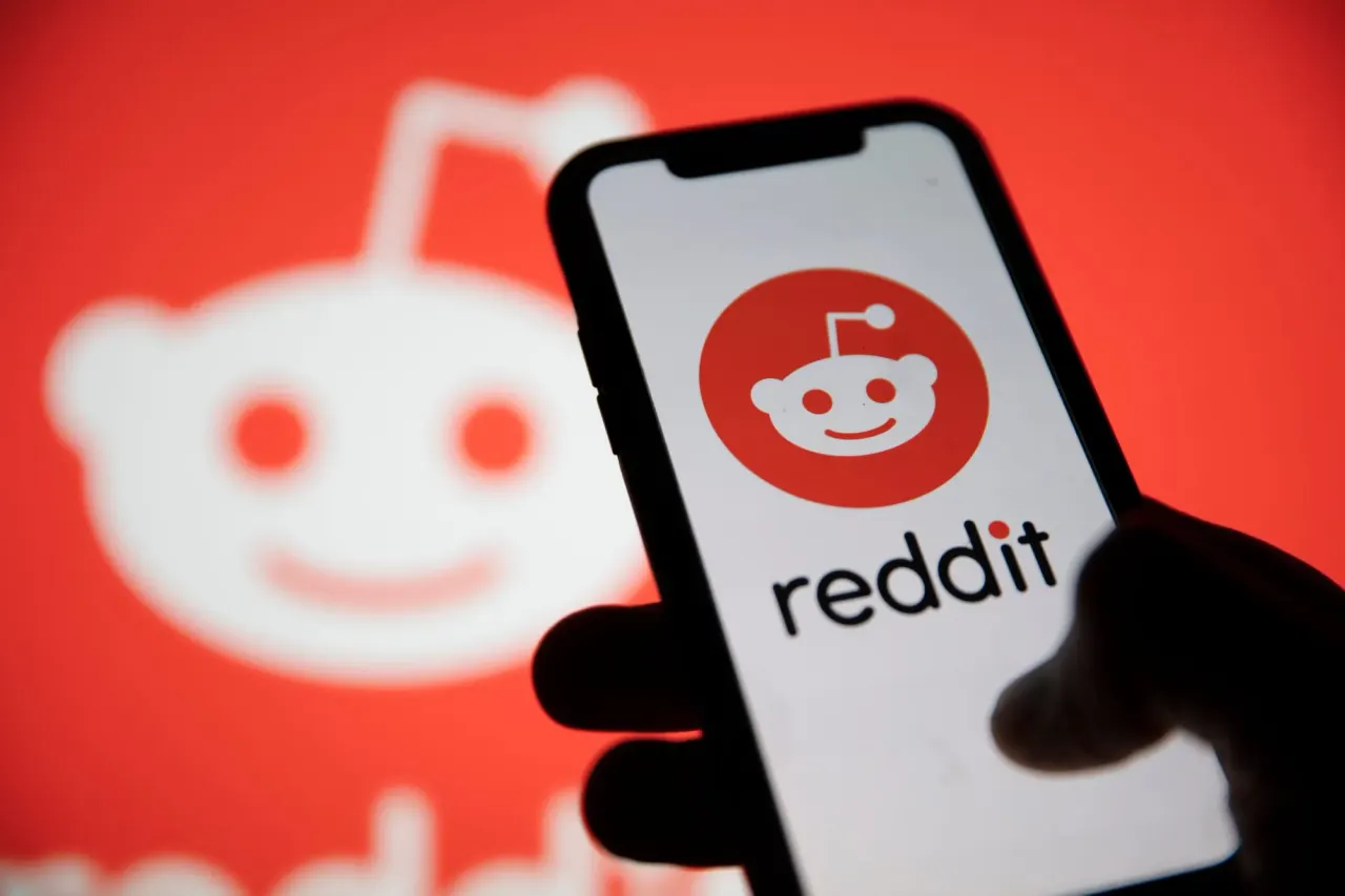 Reddit logo on a smartphone screen with a login prompt, symbolizing the platform's shift to a logged-in experience.