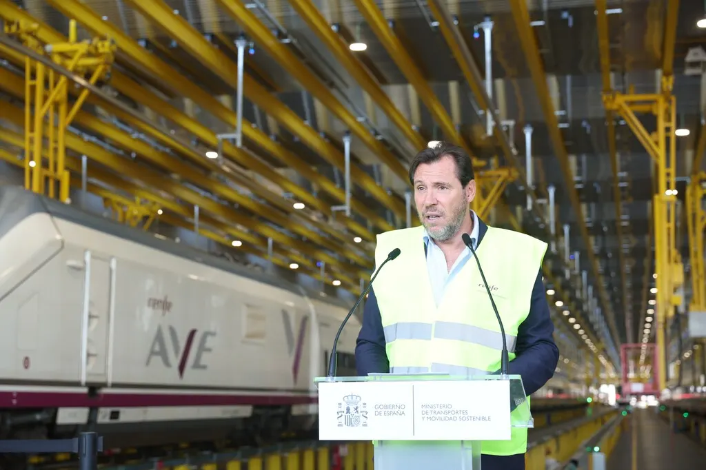 High-speed AVE train on a Spanish railway line, with a signal gantry in the foreground after the Urda crash.