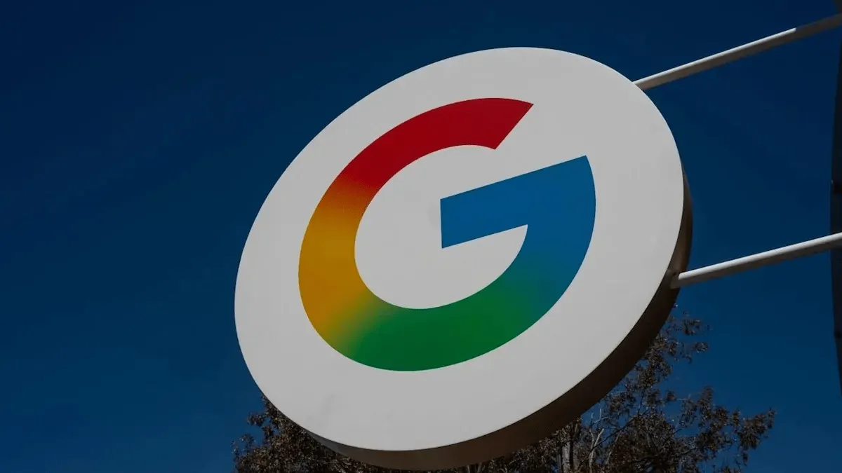 Google logo on a building facade with the Moscow skyline in the background