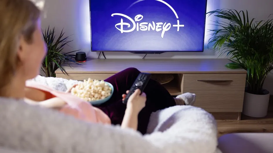 A living-room smart TV showing the Disney Plus streaming app with a 4K HDR picture.