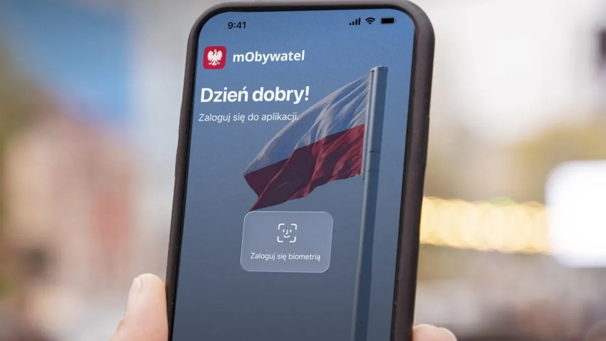 Smartphone showing the mObywatel government app next to a car key and a Polish license plate.