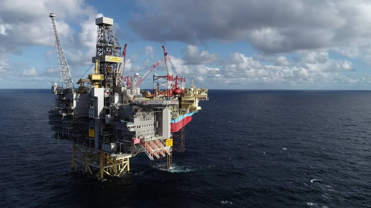 Offshore gas drilling platform in the North Sea at sunset.