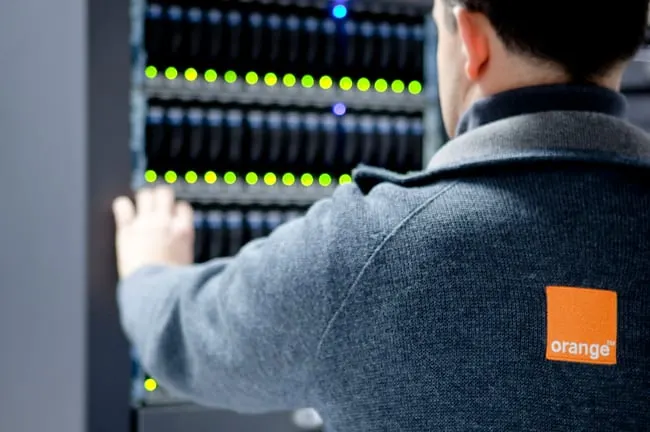 Security analysts in an operations centre monitor threat dashboards powered by an AI model.