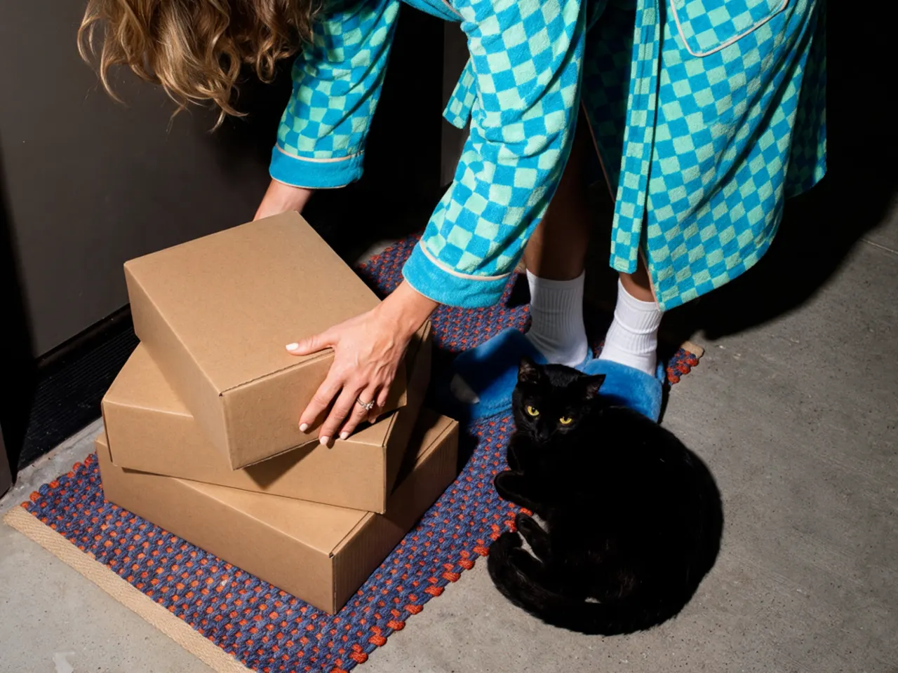 Parcels from foreign online stores stacked on a customs counter next to a calculator.