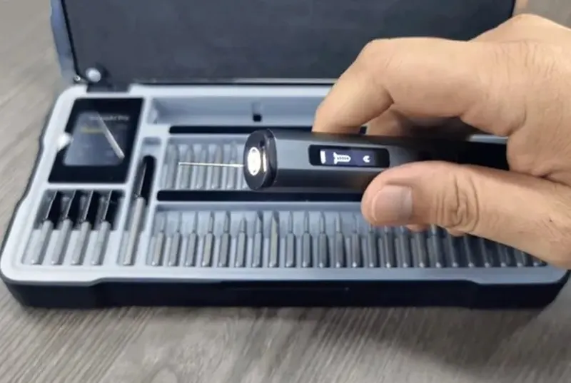 Arrowspace S1 electric screwdriver with a camera on its underside next to an open smart case of 52 bits with LED indicators.