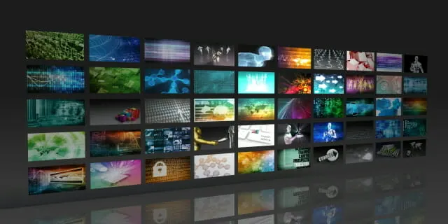Smart TV showing a streaming service menu with subscription plan options and a remote control in front of it.