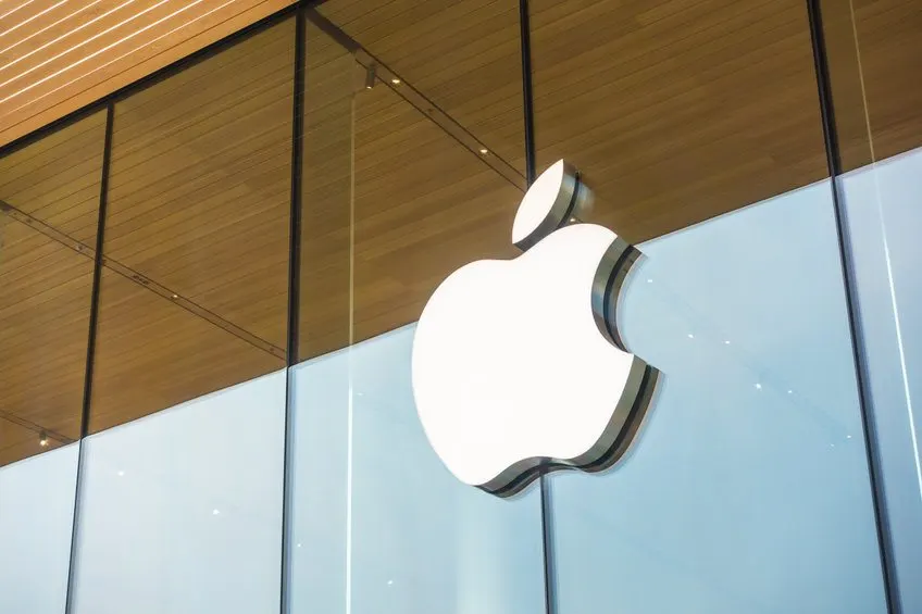 An iPhone displaying AI features next to the Alibaba and Qwen logos, representing the Apple and Alibaba partnership in China.