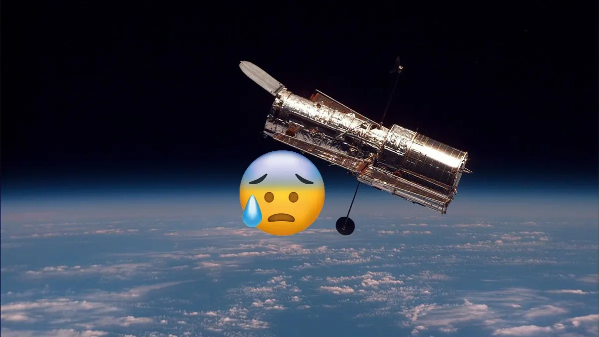 The Hubble Space Telescope orbiting Earth with its solar panels extended against the dark backdrop of space.