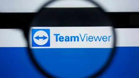 TeamViewer remote access software running on a laptop with a security warning icon